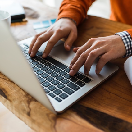 Person typing on keyboard