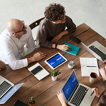 3 people having a conversation in a conference room