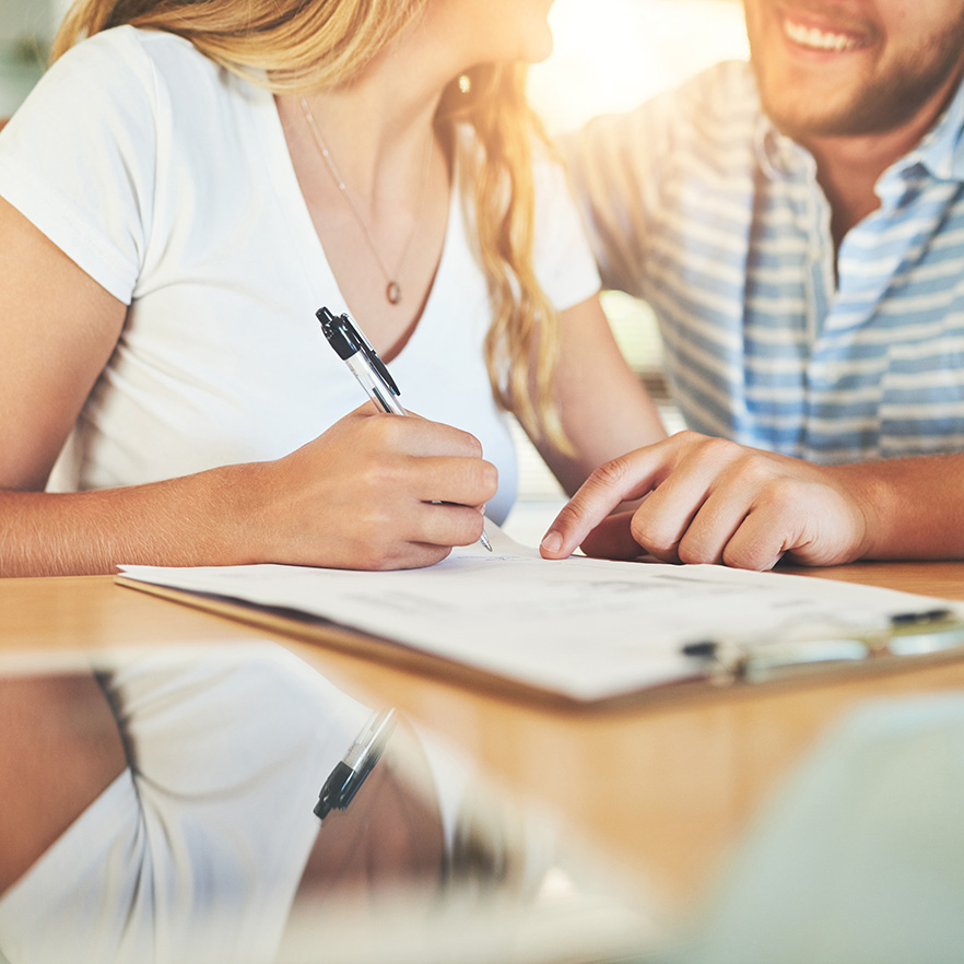 Photo of couple signing a lease