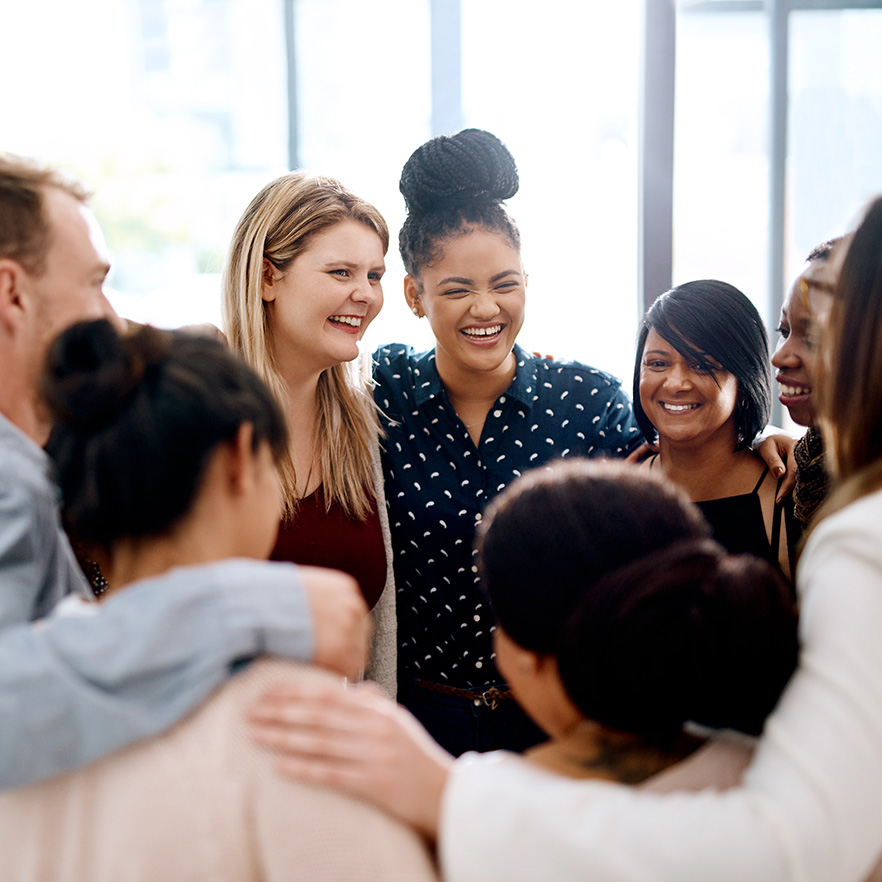 Shot of a group of businesspeople huddled together in a modern office