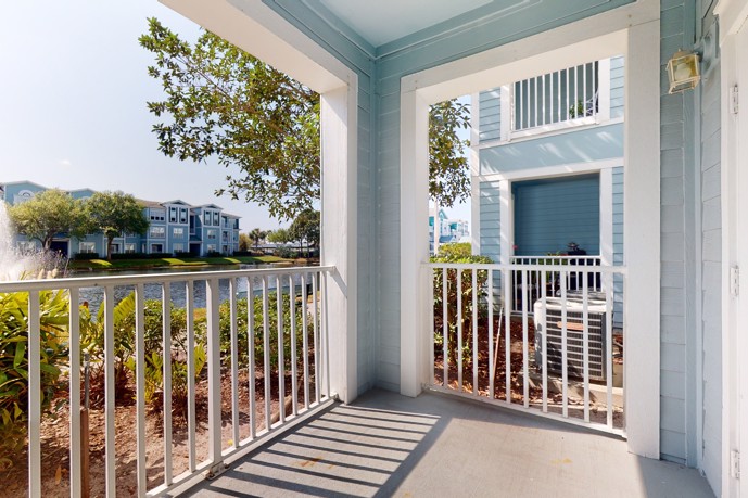 The patio at The Enclave at Tranquility Lake in Riverview, Florida, boasting picturesque views overlooking a tranquil canal, providing residents with a serene outdoor space for relaxation and enjoyment.