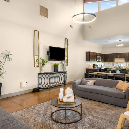 Spacious resident clubroom with fireplace and lots of comfortable seats, high ceilings, and plenty of light