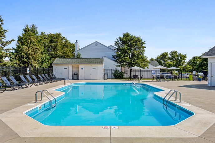 The Commons at Canal Winchester in Columbus, Ohio offers a sparkling pool with blue loungers, providing a refreshing and relaxing way to spend your day.