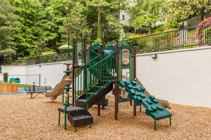 At Point at Canyon Ridge, a dedicated play area with playground equipment, all within an enclosed space.