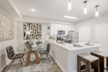 An apartment kitchen and dining area and kitchen with modern cabinetry at The Chelsea in Columbus, OH.