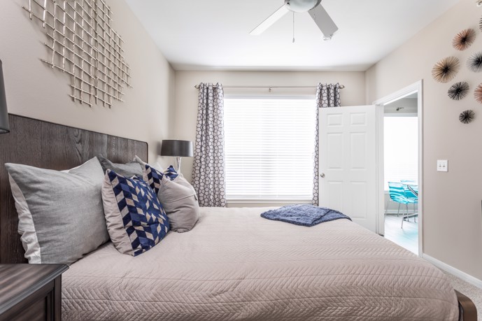 A tranquil bedroom featuring a comfortable bed, soft lighting, and tasteful decor, providing residents with a peaceful retreat for rest and relaxation.