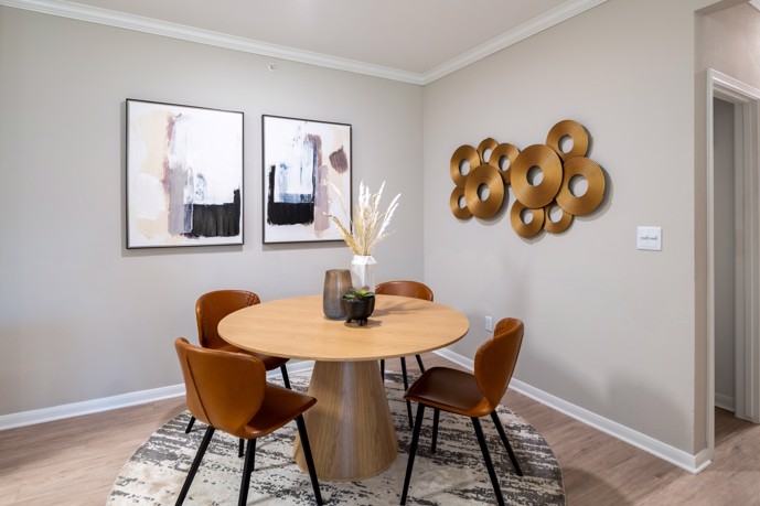 A dining area within an apartment at Pointe at Vista Ridge, featuring a contemporary round dining table.