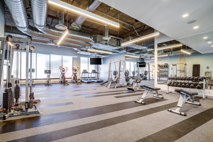 A state-of-the-art fitness center in Patina Flats at the Foundry, equipped with cardio machines, free weights, and exercise equipment
