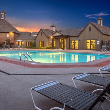 Outdoor pool surrounded by lush greenery at Riverford Crossing.