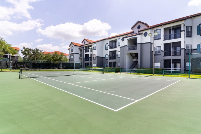 Tennis court adjacent to Lucerne's three-story apartment buildings.