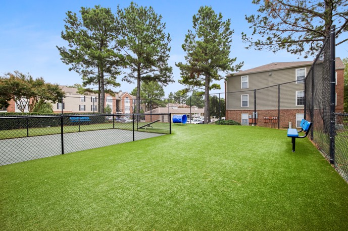 Another view of the dog park, emphasizing its amenities and spacious layout for residents' pets to roam and play freely.