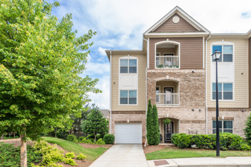 The exterior view of Waterstone at Big Creek showcases a road flanked by trees, creating a scenic and tranquil environment around the property