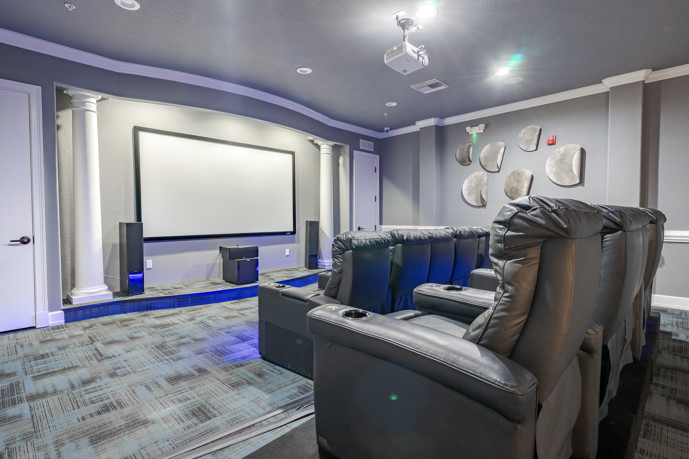 A well-appointed clubhouse featuring a movie theater for social gatherings at The Enclave at Tranquility Lake.