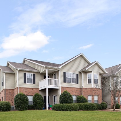 The outside view of Waterford Landing apartments featuring balconies and beautifully maintained landscaping.