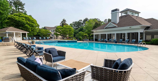 The exterior of apartments in Atlanta, GA, featuring modern architecture, balconies, and a clubhouse pool for residents to enjoy.