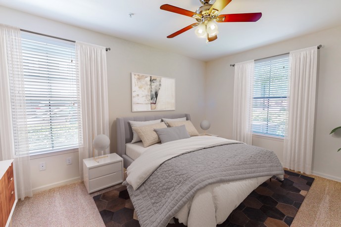 A stylishly staged bedroom in Tapestry Park, Birmingham, AL, showcasing comfortable furnishings and a serene ambiance.