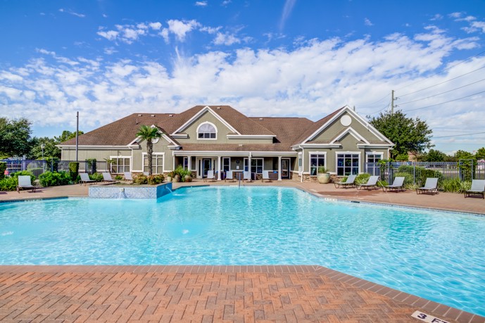 Immerse yourself in the vast expanse of the pool outside the clubhouse at Waterford Place at Riata Ranch in Cypress, Texas.