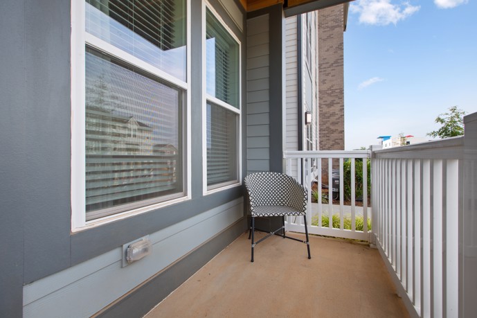 Enjoy a lovely outdoor space at the Vesta City Park apartments in Charlotte, NC, complete with a cozy chair on a charming patio.