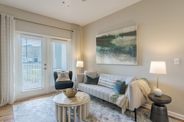 A living room featuring modern furnishings, natural lighting, and a cozy ambiance at The Enclave at Tranquility Lake in Riverview, FL.