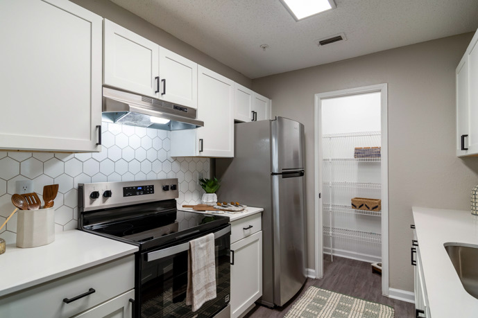 Sleek Finishes, Smart Layout - our newly renovated kitchens featuring granite countertops and white cabinets