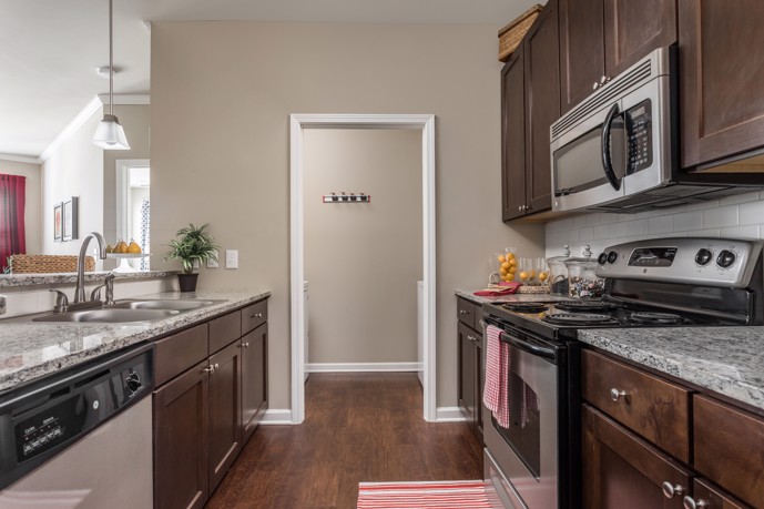 A modern and well-equipped kitchen at Talison Row, featuring contemporary appliances and ample countertop space for cooking and meal preparation