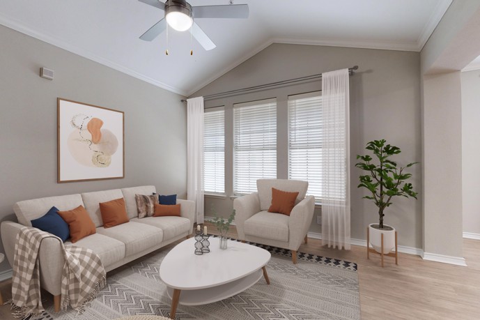 The apartment living room at The Delano at North Richland Hills, featuring a comfortable two-seater couch, wood-style flooring, and expansive windows inviting ample natural light.