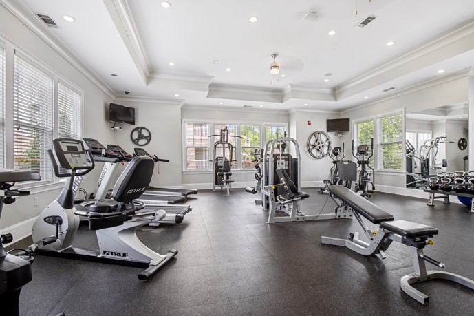 The fitness center is equipped with modern exercise machines located at St James at Goose Creek. 