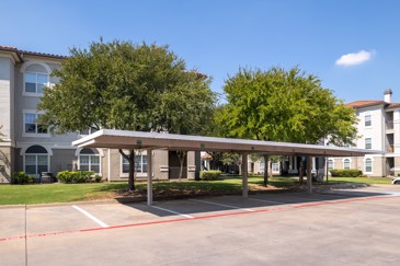 Outside the apartments at The Pointe at Vista Ridge, there are carports providing covered parking spaces for residents' vehicles, ensuring convenience and protection from the elements.