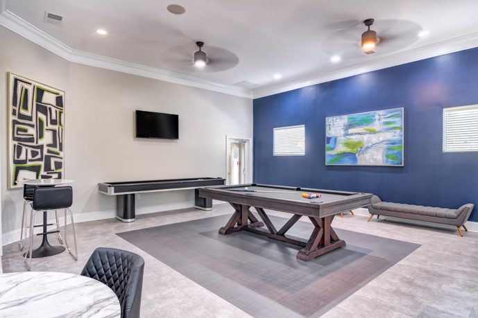 Waterstone at Big Creek offers a games room equipped with a pool table, comfortable seating, and a television for entertainment