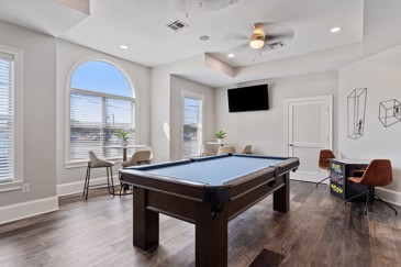 Pool table and flat screen tv in the Carrington Place apartment community clubhouse