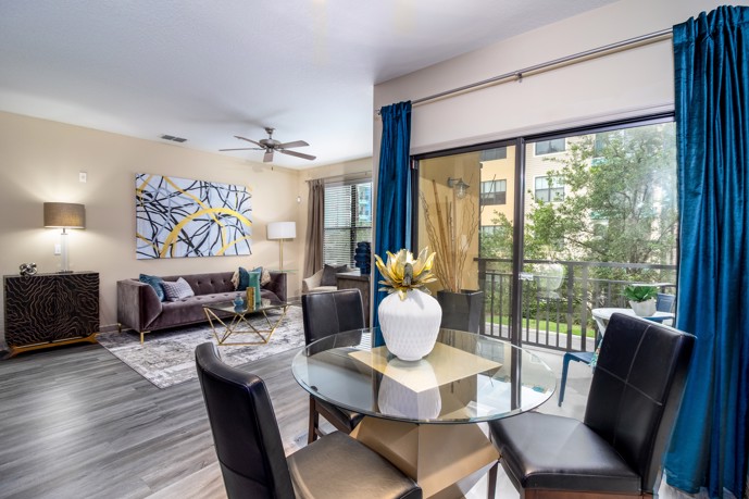 Spacious layout featuring an open floor plan, connecting a dining area with a cozy living space, complemented by double doors leading to a secluded balcony.