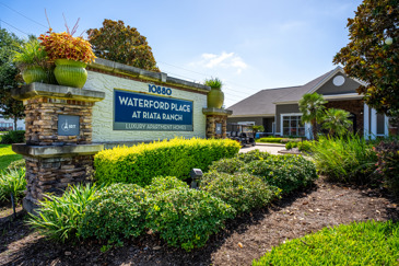 The large stone entryway sign at Waterford Place at Riata Ranch warmly welcomes you, marking the entrance with a touch of elegance and distinction.