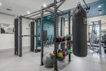 Fitness center at The Enclave at Tranquility Lake, equipped with modern exercise machines, free weights, and bright lighting, creating an energetic and motivating atmosphere.