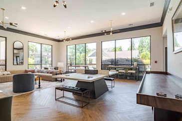 The clubhouse game room at Waterstone at Big Creek features both a pool table and a shuffleboard table, providing a fun and engaging space for residents to unwind and enjoy leisure activities.