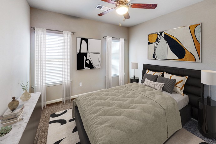A tranquil bedroom within The Shores apartments, complete with plush carpeted floors, sunlight streaming through windows, a queen bed for restful nights, and vibrant colorful artwork adding personality to the space.