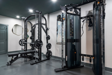 Brand new fitness center featuring smith and cable machines