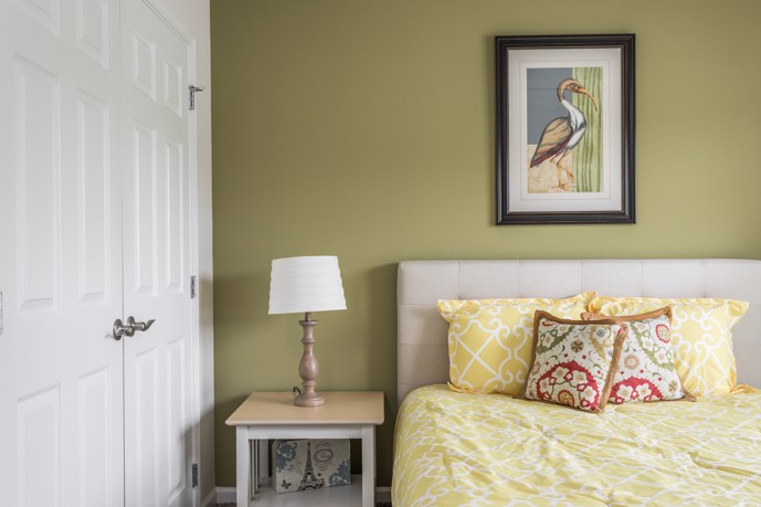 At The Tides of Calabash a serene bedroom featuring a queen bed, a spacious closet, and side tables, providing residents with a peaceful retreat for rest and relaxation.