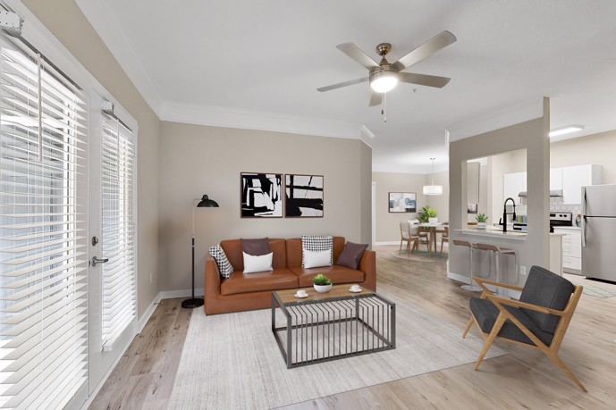 A charming apartment featuring light wood-style flooring, a well-appointed kitchen with a bar counter, and a cozy dining room at The Residences on McGinnis Ferry, in Suwanee, GA, providing residents with a comfortable and stylish living space.