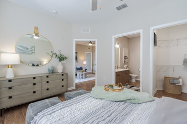 A bedroom at The Enclave at Tranquility Lake, featuring contemporary decor, a comfortable bed, bedside tables, and soft lighting.