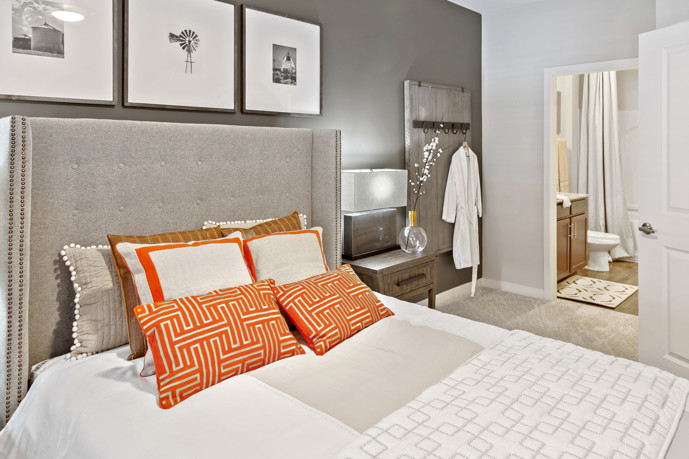 Serene bedroom featuring carpeted flooring and a window adorned with blinds.