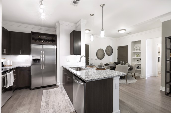 A contemporary kitchen featuring sleek cabinetry, stainless steel appliances, and spacious countertops