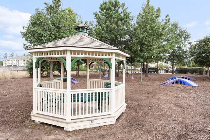 Gazebo in the middle of a an outdoor dog park with trees in the background at Creekstone at RTP apartments in Durham, NC