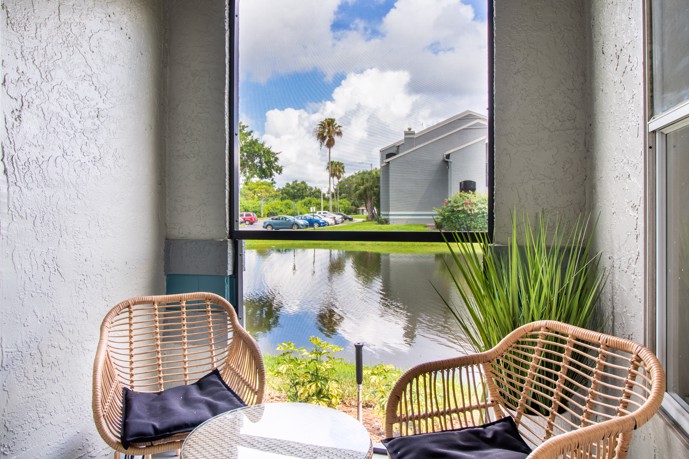 A secluded retreat with two chairs positioned by a window overlooking the tranquil canal, offering residents a serene spot for relaxation and contemplation at the Vantage on Hillsborough.