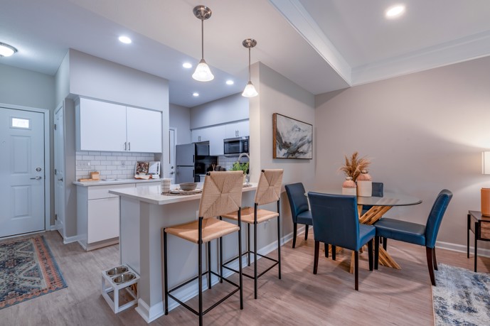 Well-lit kitchen featuring a breakfast bar, conveniently located near the entry and dining areas.