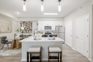 A large kitchen with modern cabinets and stainless steel appliances at The Chelsea.