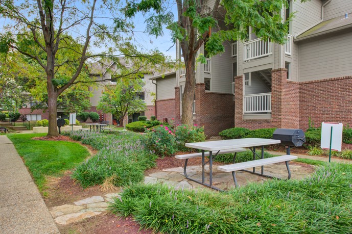 A charming picnic area within the community grounds of Prospect Park, featuring picnic tables, barbecue grills, and shaded seating areas, offering residents an ideal spot to enjoy outdoor meals, gatherings, and leisure activities in a tranquil setting.