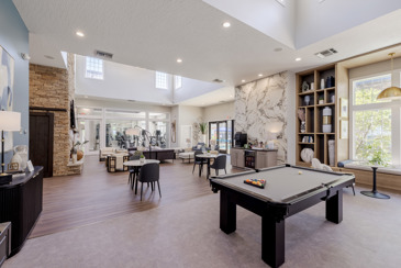 Expansive clubhouse view with a pool table offand amply seating options at The Chelsea.