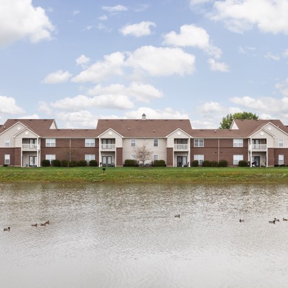 Hartshire Lakes apartment building overlooking a tranquil pond inhabited by ducks.