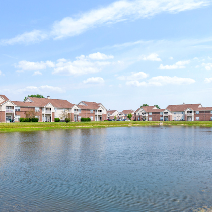 Hartshire Lakes apartment building overlooking a tranquil pond inhabited by ducks.