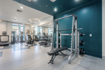 Fitness center, featuring modern exercise equipment, cardio machines, and free weights, designed to support a healthy lifestyle at The Enclave at Tranquility Lake. 